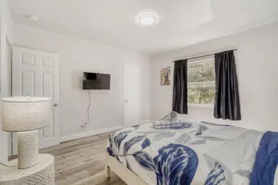 a white bedroom with a bed and a window at Lauderdale Breeze Villas - Coastal 2 Bedroom in Fort Lauderdale