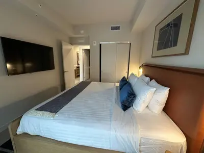 a bedroom with a large bed with a blue pillow at Sophisticated 2BR2BA at Miami World Center in Miami