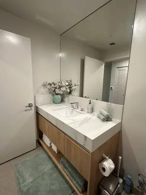 a bathroom with a sink and a large mirror at Sophisticated 2BR2BA at Miami World Center in Miami