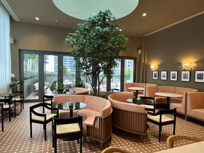 a restaurant with tables and chairs and a tree at Sophisticated 2BR2BA at Miami World Center in Miami