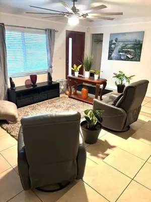 a living room with two chairs and a couch at Exclusive suites in Fort Lauderdale