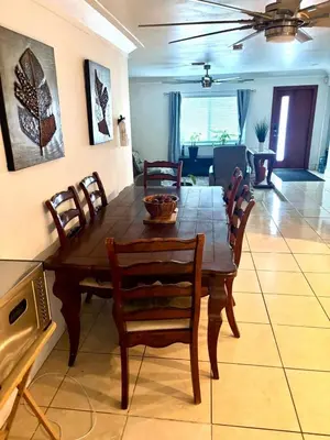 a wooden table and chairs in a living room at Exclusive suites in Fort Lauderdale