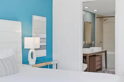 a bathroom with a sink and a toilet and a mirror at Luxury Brickell Condo with Skyline & Bay Views in Miami