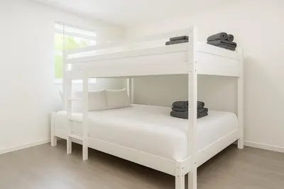 a white bunk bed in a white room at Comfy 2BR Apartment Near Las Olas with Patio, BBQ and FREE PARKING in Fort Lauderdale