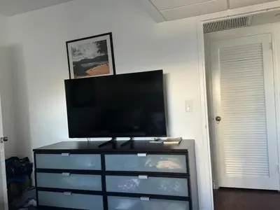 a flat screen tv sitting on top of a dresser at Hollywood Beach, Miami, Oceanfront retreat in Hollywood