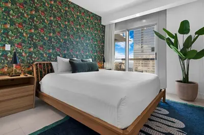 a bedroom with a large bed with a floral wallpaper at Luxury Brickell 3BD Free Parking - Pool - Bay View in Miami