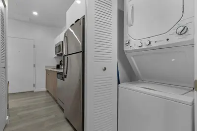 a kitchen with a stainless steel refrigerator and a counter at Voy House Wynwood with Rooftop Pool in Miami