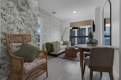 a living room with a table and a dining room at Voy House Wynwood with Rooftop Pool in Miami