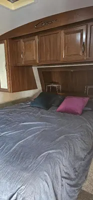 a bedroom with a large bed with wooden cabinets at Getsemany Inc RV Dreams Hollywood in Hollywood