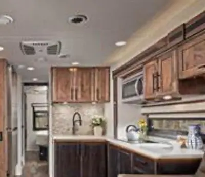 a kitchen with wooden cabinets and a sink at Getsemany Inc RV Dreams Hollywood in Hollywood