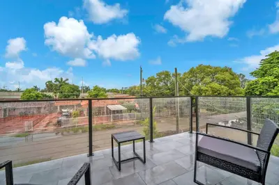 a patio with a table and chairs on a balcony at Sandra's Place - Family - Entire 8BR-6BA in Miami
