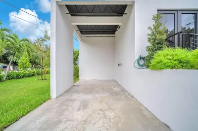 a walkway leading into a white house at Sandra's Place - Family - Entire 8BR-6BA in Miami