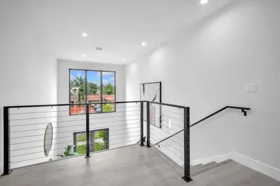 a staircase in a house with a white wall at Sandra's Place - Family - Entire 8BR-6BA in Miami