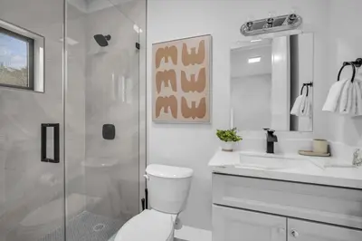 a bathroom with a shower and a toilet and a sink at Sandra's Place - Family - Entire 8BR-6BA in Miami