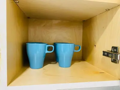 two blue cups sitting on top of a shelf at West Brickell #2 Renovated 2 2 Apt + Parking in Miami