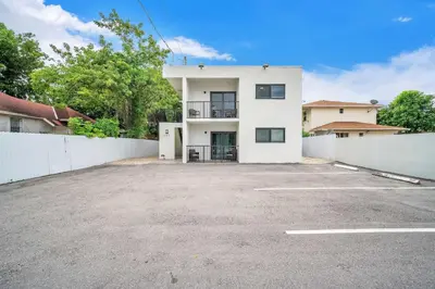 an empty parking lot in front of a white building at West Brickell #2 Renovated 2 2 Apt + Parking in Miami