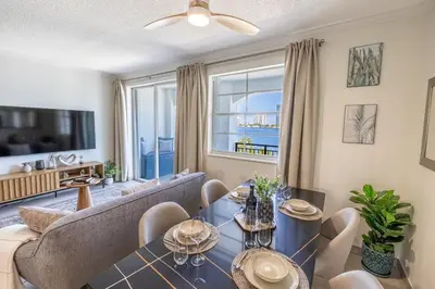 a living room with a couch and a table at Serene Waterfront Condo - Bayview, pool & tennis in Aventura