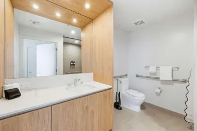 a bathroom with a sink and a toilet and a mirror at Downtown Drift-Luxury Amenities Sauna & Pool in Miami