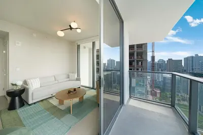 a living room with a white couch on a balcony at Downtown Drift-Luxury Amenities Sauna & Pool in Miami