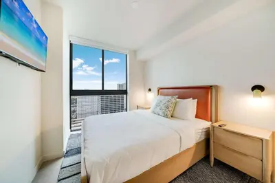 a bedroom with a bed and a large window at Downtown Drift-Luxury Amenities Sauna & Pool in Miami
