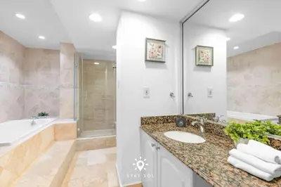 a bathroom with a sink and a tub and a shower at Luxury by the Sea- 2BR Pool & Gym -Hollywood in Hollywood