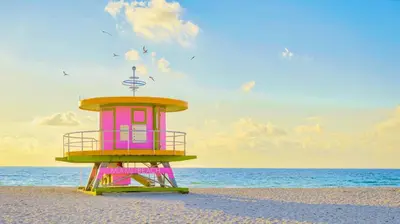a pink and yellow lifeguard tower on the beach at Casa Collins in Miami Beach
