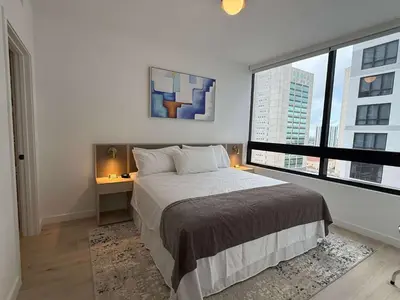a bedroom with a bed and a large window at Downtown Miami 1BR Walk to Bayside Kaseya Gym Pool in Miami
