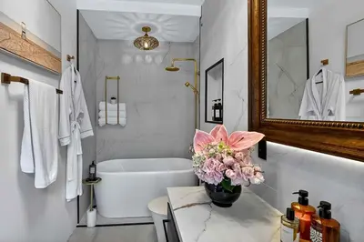 a bathroom with a tub and a vase of flowers at Villa 800 - 3 BEDROOM - 3 AND A HALF BATHROOMS -6 BEDS- Spa like Retreat Saline Pool & Jacuzzi in Miami