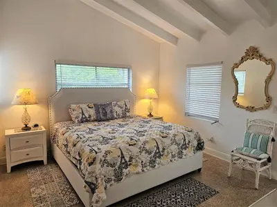 a bedroom with a bed and a mirror and a chair at Holiday Home Guest House at the Ocean by Interhome in Fort Lauderdale