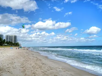a beach with a kite flying over the ocean at Holiday Home Guest House at the Ocean by Interhome in Fort Lauderdale