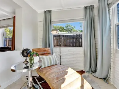 a living room with a table and a chair and a window at Holiday Home 2BR - 2 bath Beheizter Pool- Familien-Haustierfreundlicher Spaß by Interhome in Fort Lauderdale
