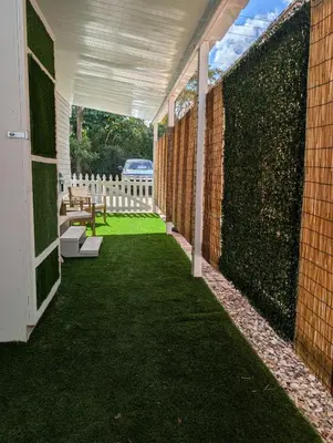 an enclosed patio with a fence and a bench at PrimeStay Modern Studio in Prime Location in Hollywood