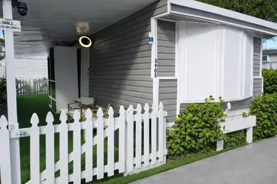 a white picket fence in front of a house at PrimeStay Modern Studio in Prime Location in Hollywood