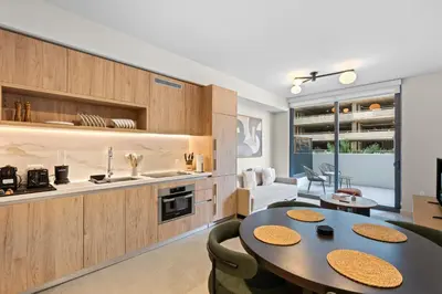 a kitchen and living room with a table and chairs at Modern Condo in Downtown Miami Near Bayside in Miami