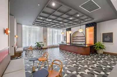 a lobby with tables and chairs in a building at Modern Condo in Downtown Miami Near Bayside in Miami