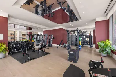 a gym with a lot of treadmills and machines at Modern Condo in Downtown Miami Near Bayside in Miami