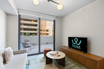a living room with a couch and a tv at Modern Condo in Downtown Miami Near Bayside in Miami