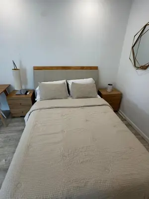 a large bed in a bedroom with two night stands at Central location in Cutler Bay