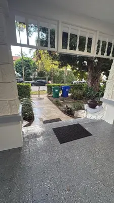 a porch of a house with windows and a yard at Villa Habana in Miami