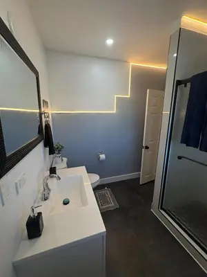 a bathroom with a white sink and a mirror at Villa Habana in Miami