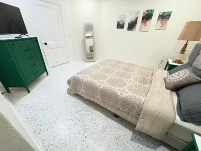 a bedroom with a bed and a green dresser at Villa Habana in Miami