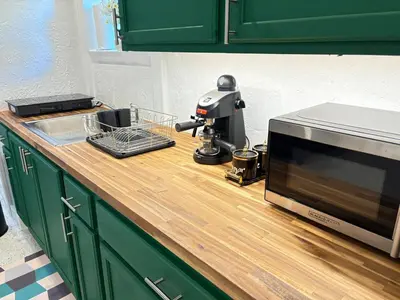 a kitchen counter with a microwave on top of it at Villa Habana in Miami