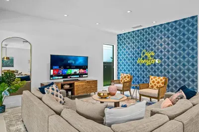a living room with a couch and a tv at Casa Monstera Heated Saltwater Pool Game Room Golf in Fort Lauderdale