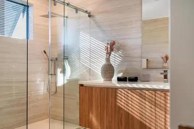 a bathroom with a shower with a vase on a counter at Casa Monstera Heated Saltwater Pool Game Room Golf in Fort Lauderdale