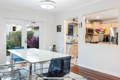 a kitchen with a dining room table and chairs at Private Oasis with Heated Saltwater Pool Tropical Backyard in Dania Beach