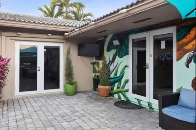 a house with a mural on the side of it at Private Oasis with Heated Saltwater Pool Tropical Backyard in Dania Beach