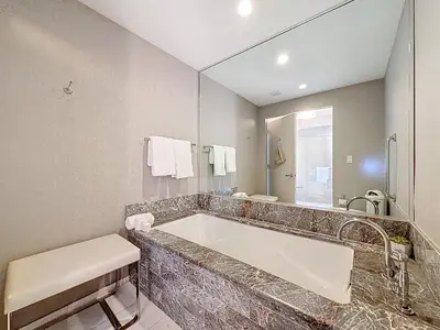 a bathroom with a large tub and a large mirror at Fort Lauderdale Beach Luxury - Ocean View Condo in Fort Lauderdale