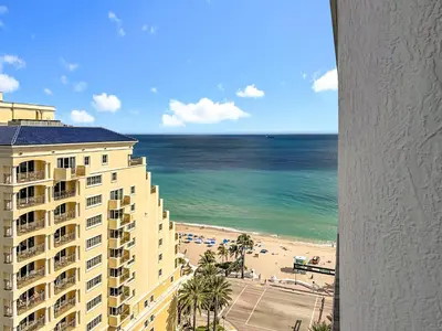 a view of a hotel and the beach from a window at Fort Lauderdale Beach Luxury - Ocean View Condo in Fort Lauderdale