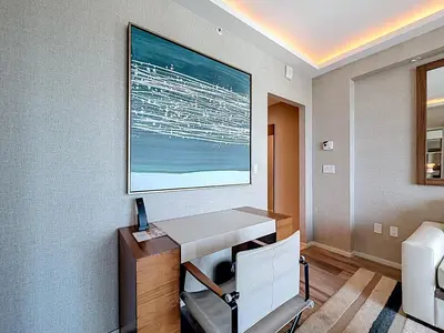 a room with a desk and a picture on the wall at Fort Lauderdale Beach Luxury - Ocean View Condo in Fort Lauderdale