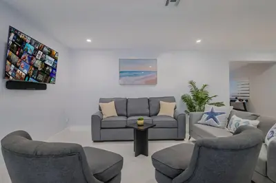 a living room with a couch and two chairs at 4 Bedroom Villa Pool Game Room By Beach & Hard Rock in Pembroke Pines